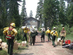 Green Knoll firefighters work to save a home near Wilson, Wyoming