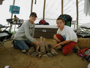 Matthew from Texas and Rodney from Casper build the campfire in their tipi