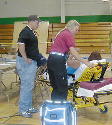 A patient is secured during the medical screening during the mock terrorism drill at the high school. Pinedale Online photo.
