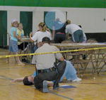 Victim passes out while waiting for treatment.