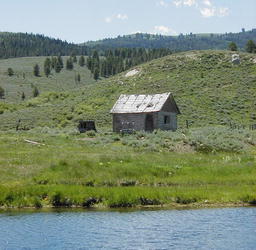 Fire conditions currently are moderate. This old cabin and lake are up in Bondurant. Photo by Pinedale Online.