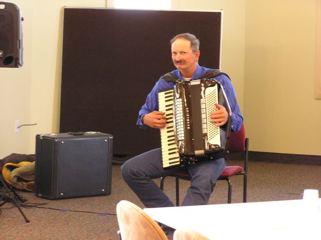 Rudy plays the accordian. Photo by Pinedale Online.