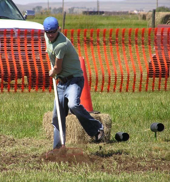 Raking the dirt. Photo by Dawn Ballou, Pinedale Online.