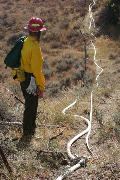 Checking the hose lay. Photo by Clint Gilchrist, Pinedale Online.