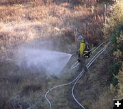 Wetting down the fireline. Photo by Dawn Ballou, Pinedale Online.