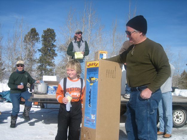 Jacob wins ice auger. Photo by Bill Boender.