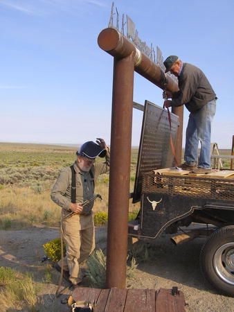 Hanging the sign. Photo by Sublette County Museum Board.