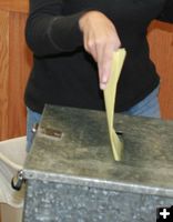 Into the ballot box. Photo by Dawn Ballou, Pinedale Online.