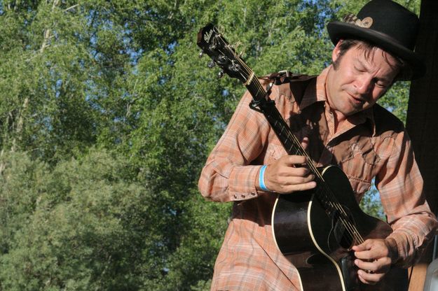 Crossland on the guitar. Photo by Tim Ruland, Pinedale Fine Arts Council.