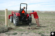 Digging fence post holes. Photo by Dawn Ballou, Pinedale Online.