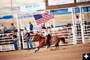 Flag parade. Photo by Tara Bolgiano, Blushing Crow Photography.