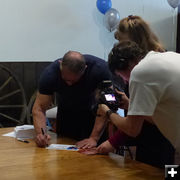 Signing autographs. Photo by Dawn Ballou, Pinedale Online.