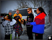 Passing out warm hats. Photo by Terry Allen.