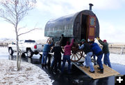 Putting the wagon on the trailer. Photo by Dawn Ballou, Pinedale Online.