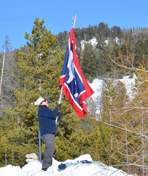 Courtney Lowers the Flag. Photo by Terry Allen.