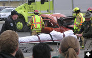 Taking away dead body. Photo by Bob Rule, KPIN 101.1FM Radio.