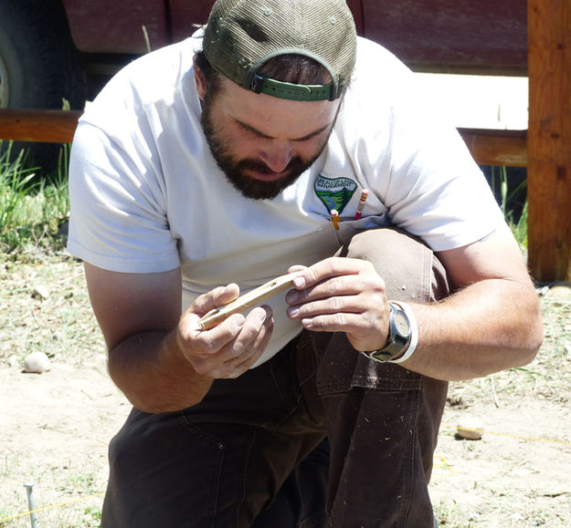 Examining chunk. Photo by Dawn Ballou, Pinedale Online.