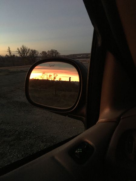 Sunrise in rear view mirror. Photo by Renee' Smythe.