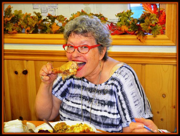 Rev. Carol Samples the Turkey. Photo by Terry Allen.