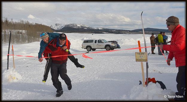 Darren Carries Gabe Across Finish. Photo by Terry Allen.