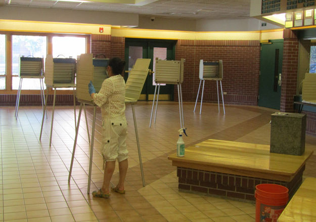 Disinfecting voting booths. Photo by Dawn Ballou, Pinedale Online.