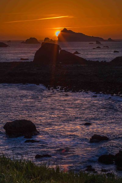 Setting Sun Behind Castle Island. Photo by Dave Bell.