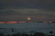 Lit Peaks With Full Moon. Photo by Dave Bell.