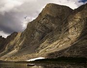 Sunlight Touches Baptiste Lake Big Walls. Photo by Dave Bell.