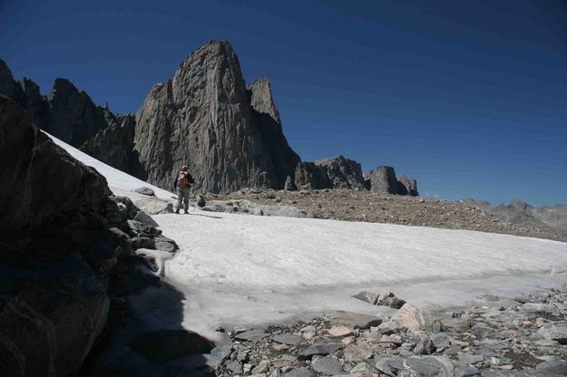 Hiker Across Snowfield And Pronghorn. Photo by Dave Bell.