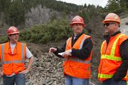 Geologists Mark Faulk and Kirk Hood Confer With Engineer Pete Hallsten. Photo by Dave Bell.