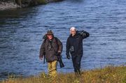 Anderson Cooper Schlepping Tom Mangelsen's Photography Gear. Photo by Dave Bell.