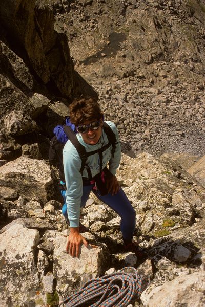 Sue resting after doing new 5.7 A1 route on Northwest Face of Stroud Pk. / Shannon Pass below / Wind River Mtns. / Wyoming / circa 1988. Photo by Fred Pflughoft.