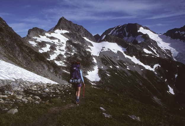 Sue heading towards Koolaid Lk. / Ptarmigan Traverse / High alpine traverse in the central Cascades / Washington / circa 1985. Photo by Fred Pflughoft.