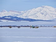 A Rancher unloading hay for the cattle. Photo by Scott Almdale.