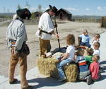 Badger and Two Bears give a deonstration about early 1800s firearms to  Pinedale Preschool children on Friday