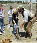 Jim demonstrates springing a beaver trap to Pinedale 4th graders