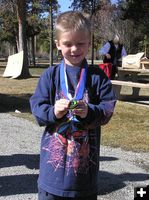 Tanner shows off his medals. Photo by Dawn Ballou, Pinedale Online.
