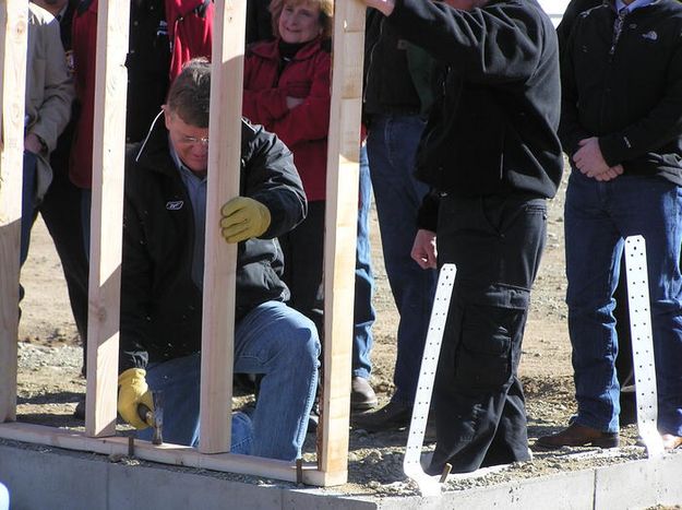 Governor pounds in nail. Photo by Dawn Ballou, Pinedale Online.