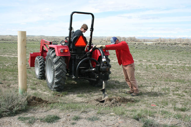 Digging fence post holes. Photo by Dawn Ballou, Pinedale Online.