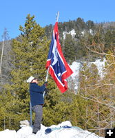 Courtney Lowers the Flag. Photo by Terry Allen.