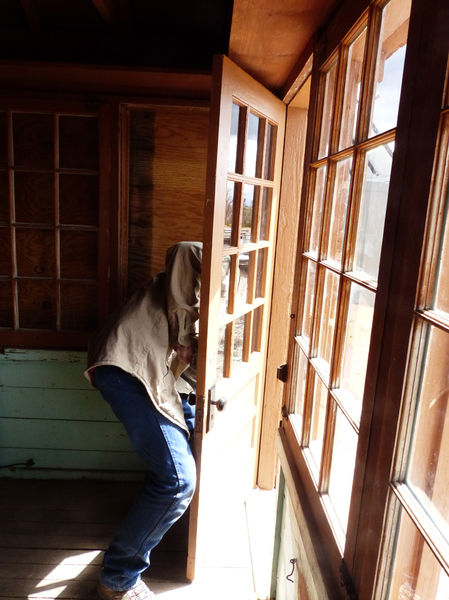 Adjusting door fitting. Photo by Dawn Ballou, Pinedale Online.