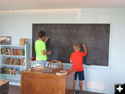 Writing on the chalk board. Photo by Dawn Ballou, Pinedale Online.