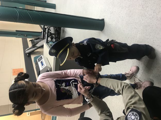 Putting on handcuffs. Photo by Sublette County Sheriff's Office.