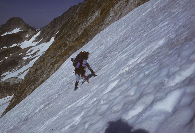 Sue down climbing off the col above Middle Cascade Glacier / Ptarmigan Traverse / Washington / circa 1985. Photo by Fred Pflughoft.